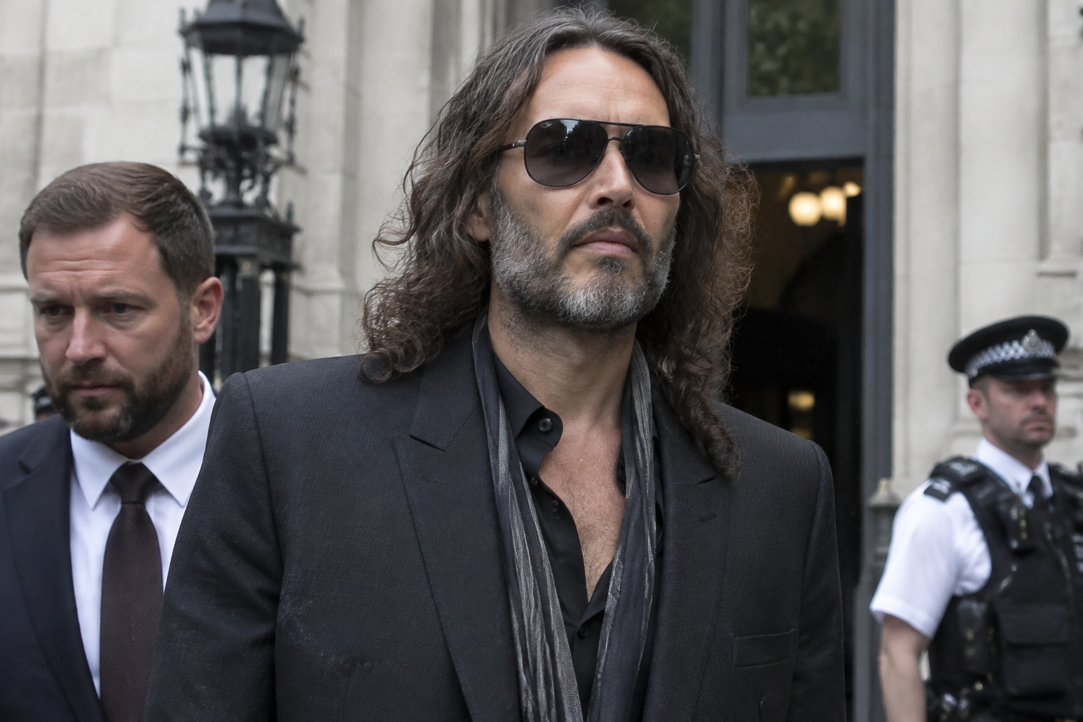 Russell Brand appears in court as rape trial begins